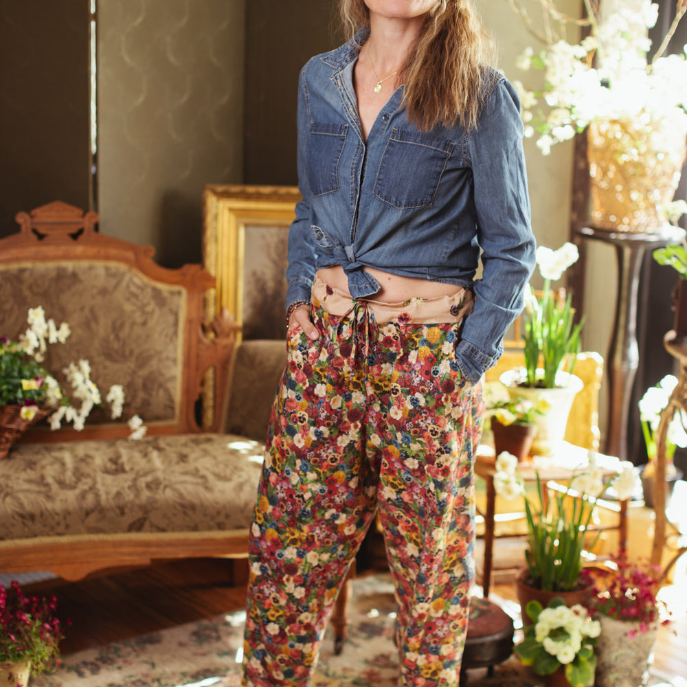 Artist pants featuring a whimsical print of 50 antique seed catalogue flowers arranged on a painter’s palette with a Monet quote – Market of Stars.