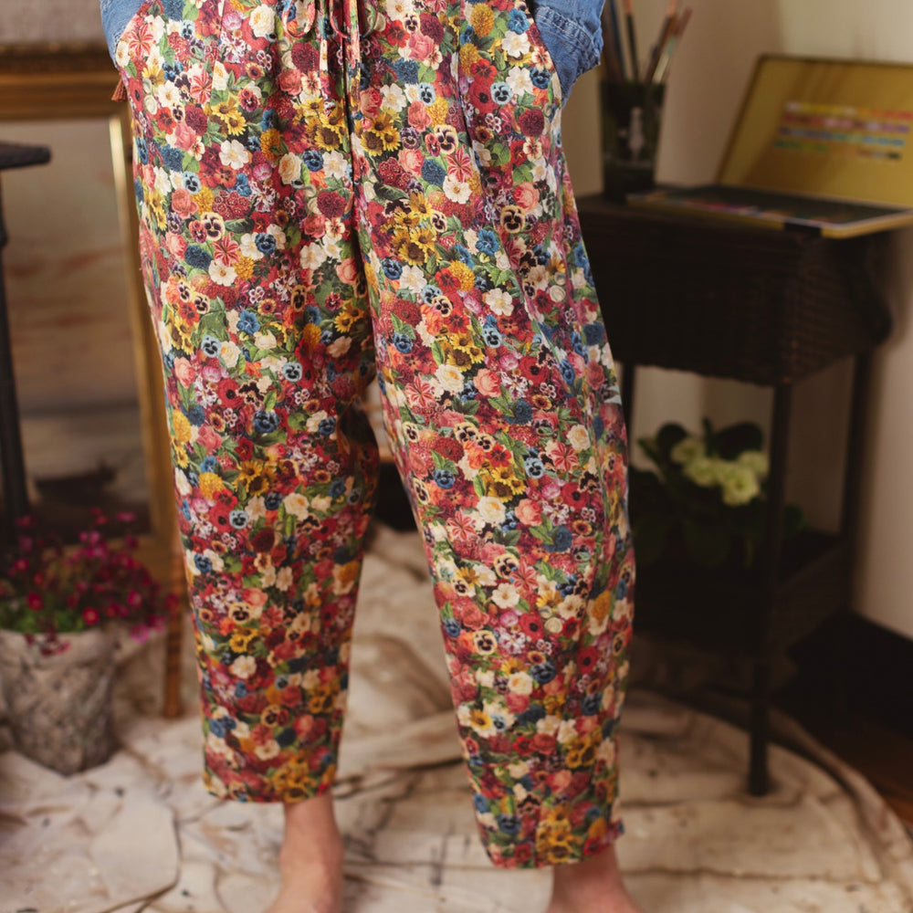 Artist pants featuring a whimsical print of 50 antique seed catalogue flowers arranged on a painter’s palette with a Monet quote – Market of Stars.