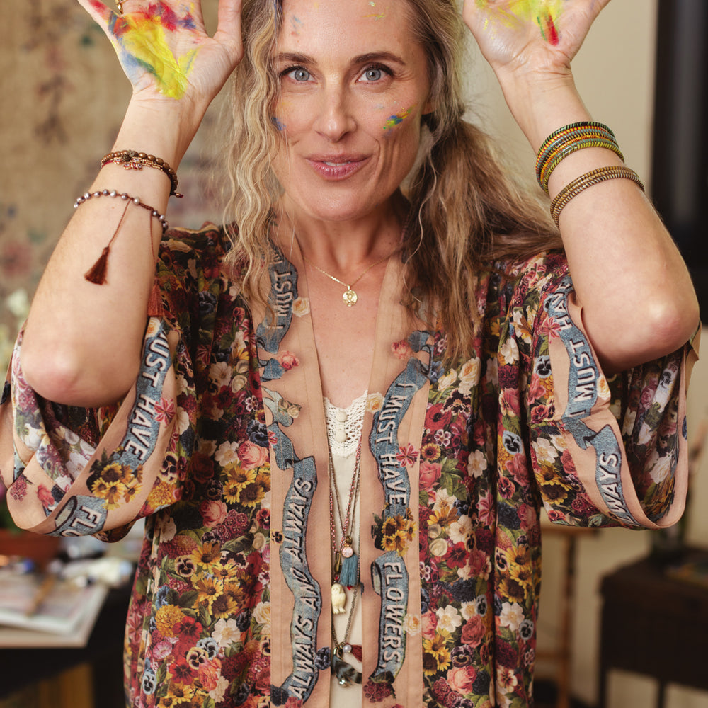 
                  
                    Short kimono featuring a whimsical artist’s palette and over 50 layered flowers from antique seed catalogues, inspired by Claude Monet – Market of Stars.
                  
                