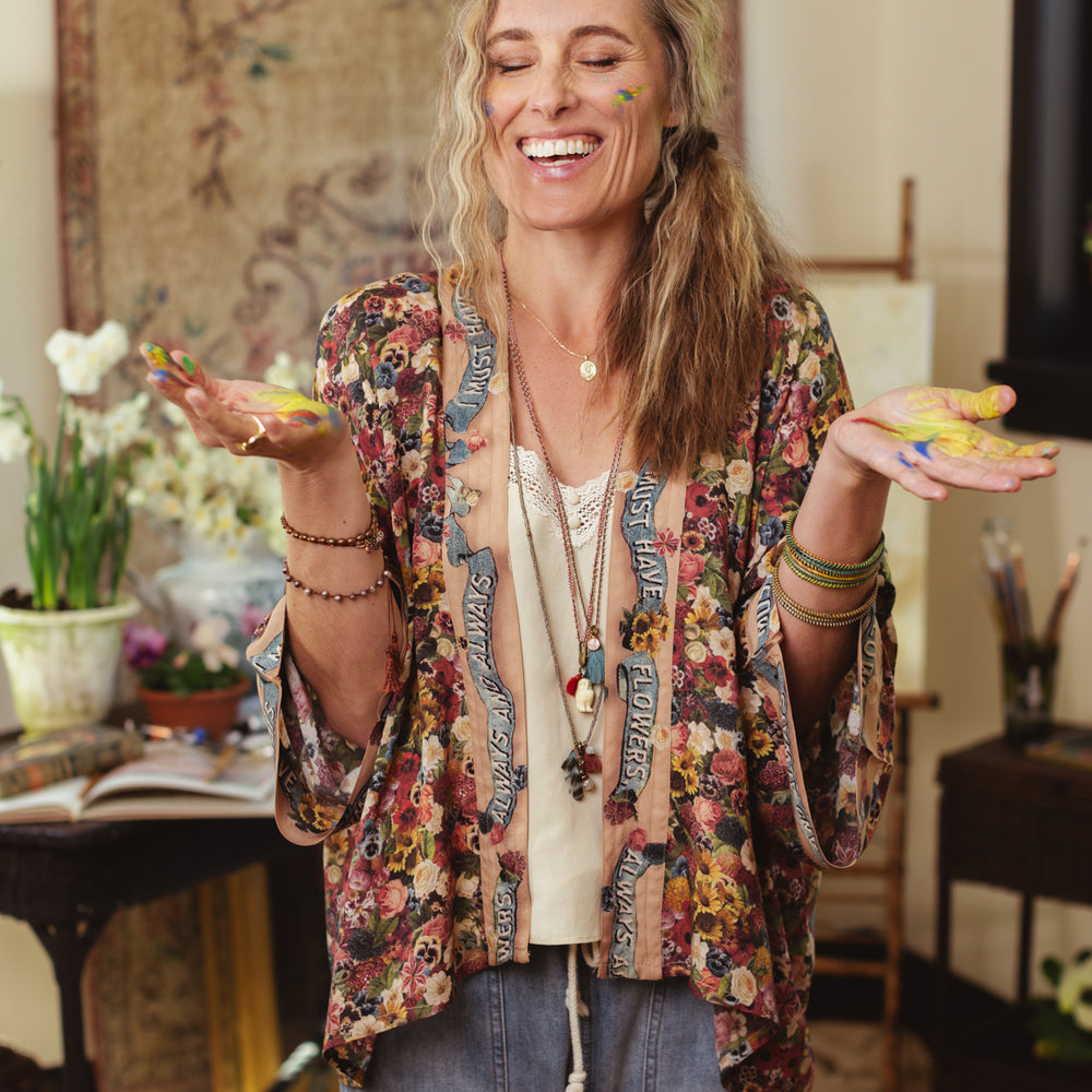 
                  
                    Short kimono featuring a whimsical artist’s palette and over 50 layered flowers from antique seed catalogues, inspired by Claude Monet – Market of Stars.
                  
                