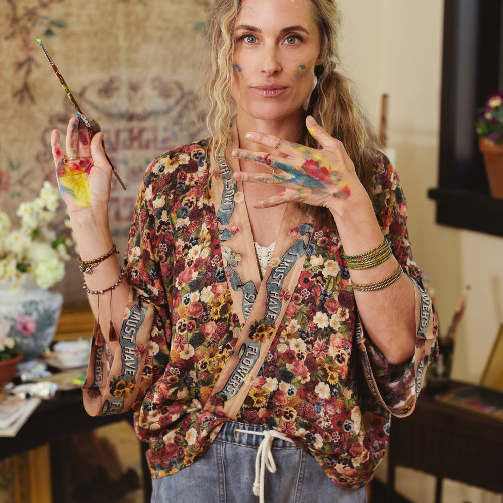 
                  
                    Short kimono featuring a whimsical artist’s palette and over 50 layered flowers from antique seed catalogues, inspired by Claude Monet – Market of Stars.
                  
                