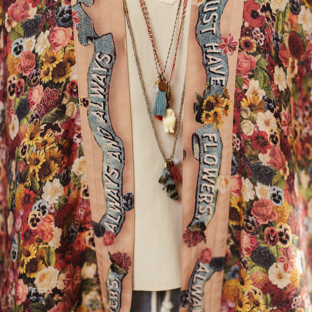 
                  
                    Short kimono featuring a whimsical artist’s palette and over 50 layered flowers from antique seed catalogues, inspired by Claude Monet – Market of Stars.
                  
                