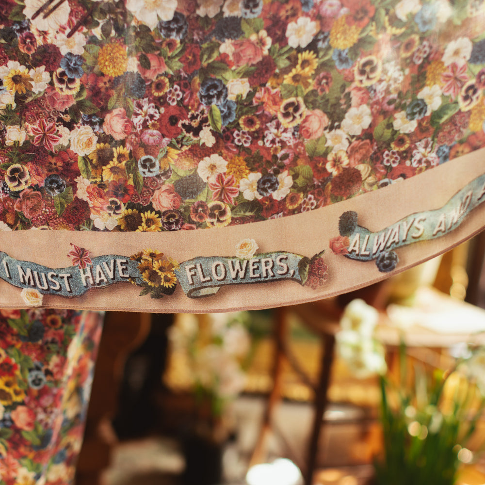 
                  
                    Soft viscose scarf featuring a vintage artist’s paint palette with floral details and over 50 layered blooms from 1800’s seed catalogues, inspired by Claude Monet – Market of Stars
                  
                