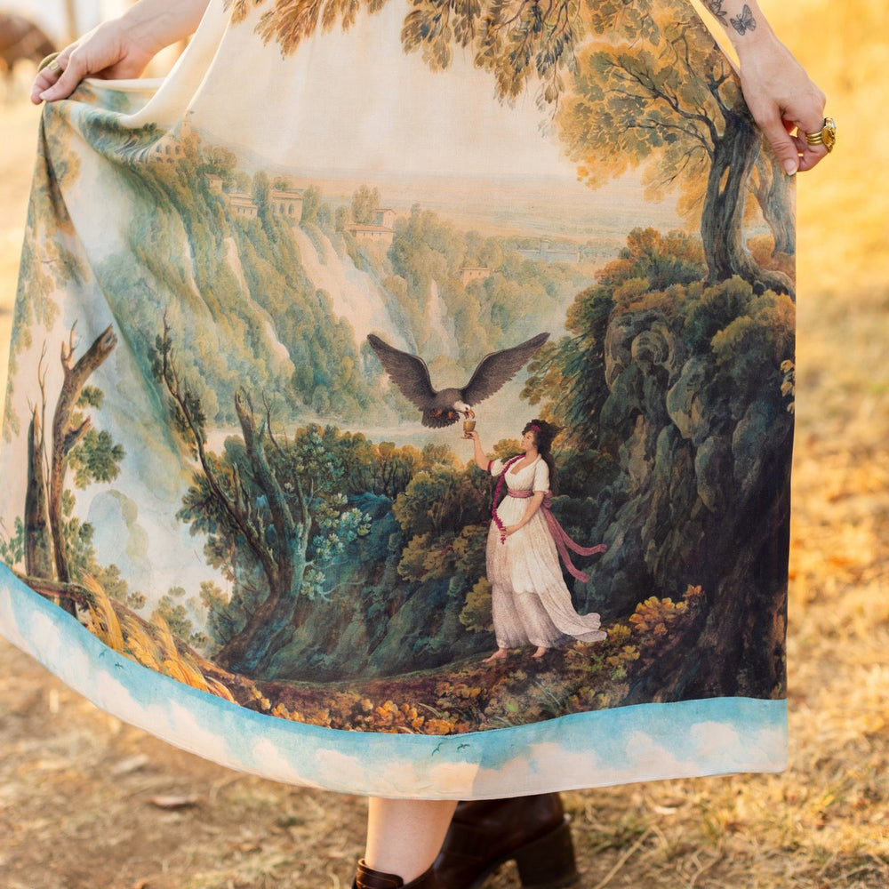 
                  
                    Soft bamboo viscose Bohéme slip dress featuring 18th-century Tivoli waterfalls and Lady Liberty artwork, designed to celebrate self-love and personal power – Market of Stars.
                  
                