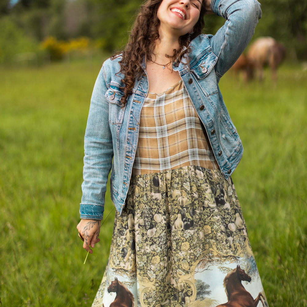 
                  
                    Model wearing a bamboo-viscose maxi-length slip dress made for everyday adventures with a whimsical print celebrating one's unbridled spirit of adventure - Market of Stars
                  
                