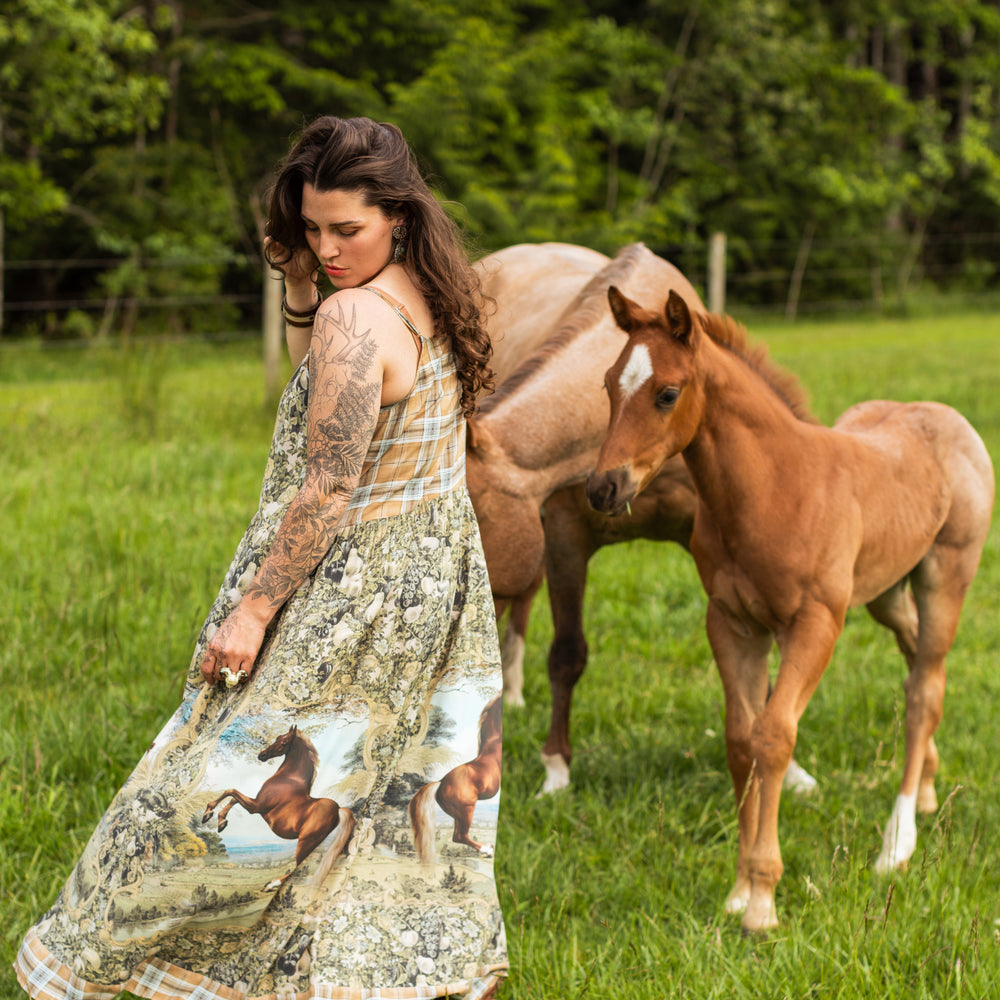 
                  
                    Model wearing a bamboo-viscose maxi-length slip dress made for everyday adventures with a whimsical print celebrating one's unbridled spirit of adventure - Market of Stars
                  
                