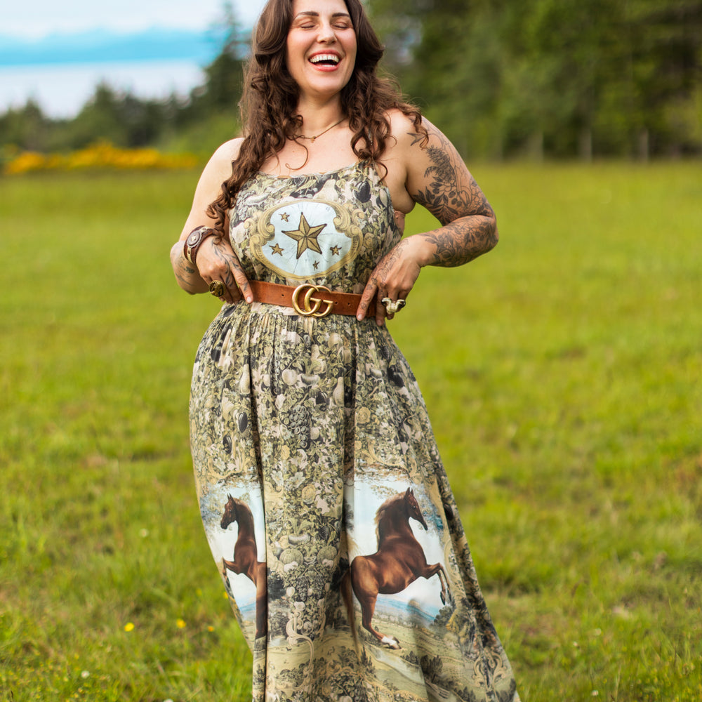 
                  
                    Model wearing a bamboo-viscose maxi-length slip dress made for everyday adventures with a whimsical print celebrating one's unbridled spirit of adventure - Market of Stars
                  
                