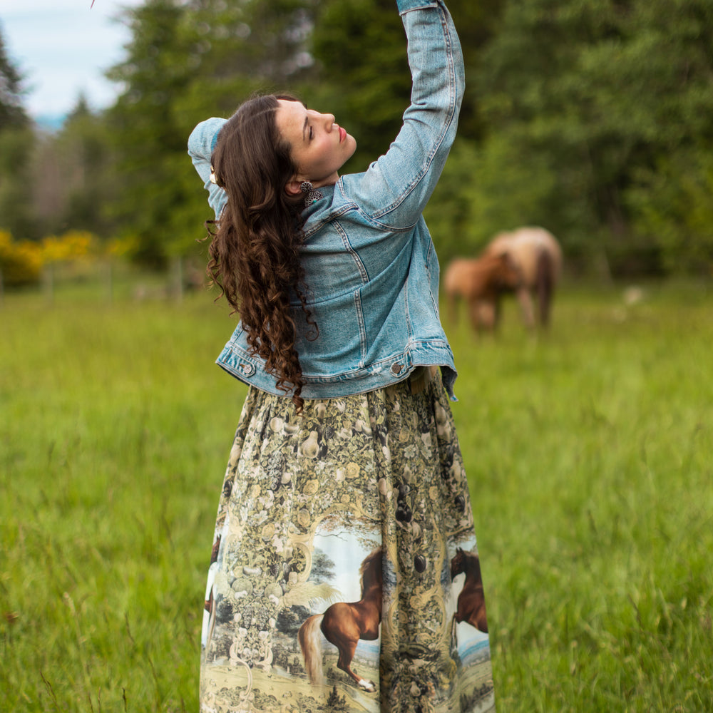 
                  
                    Model wearing a bamboo-viscose maxi-length slip dress made for everyday adventures with a whimsical print celebrating one's unbridled spirit of adventure - Market of Stars
                  
                