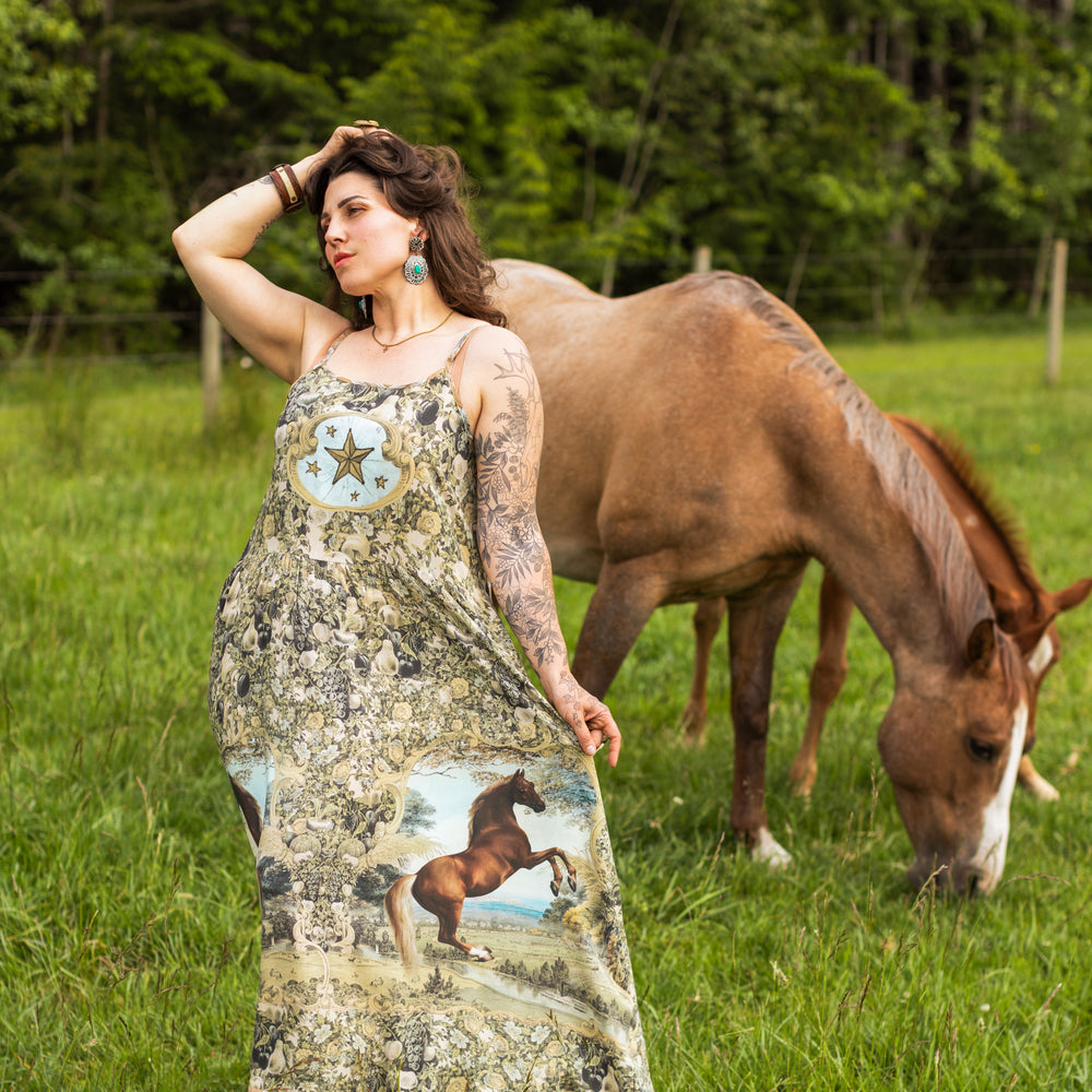 Model wearing a bamboo-viscose maxi-length slip dress made for everyday adventures with a whimsical print celebrating one's unbridled spirit of adventure - Market of Stars
