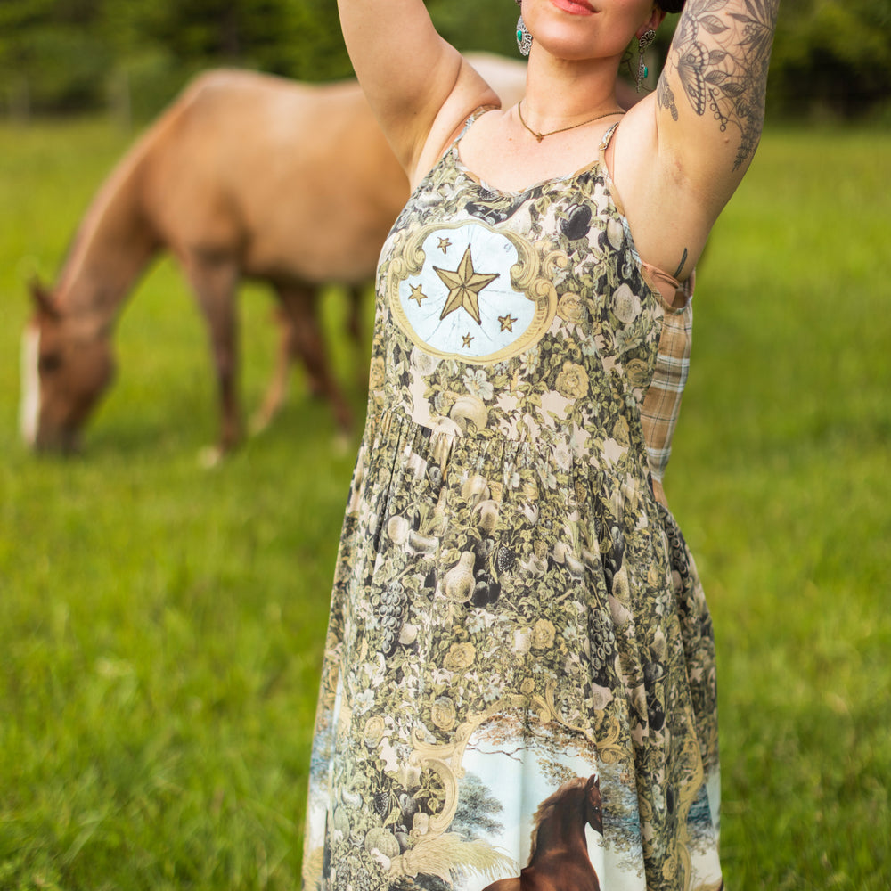 
                  
                    Model wearing a bamboo-viscose maxi-length slip dress made for everyday adventures with a whimsical print celebrating one's unbridled spirit of adventure - Market of Stars
                  
                