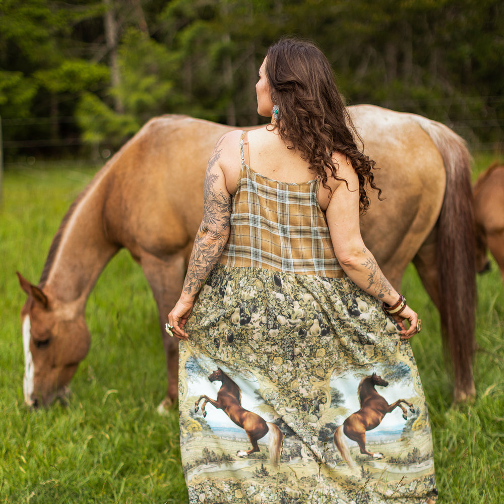 
                  
                    Model wearing a bamboo-viscose maxi-length slip dress made for everyday adventures with a whimsical print celebrating one's unbridled spirit of adventure - Market of Stars
                  
                
