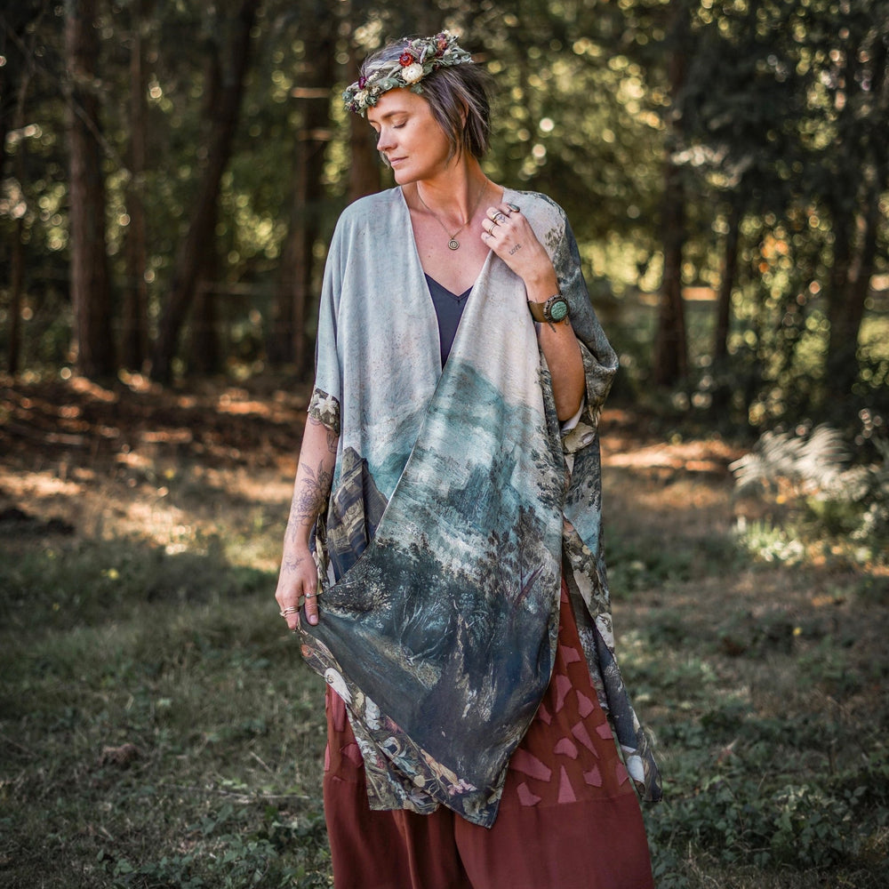 Castles in the Air Starduster kimono featuring Brueghel’s 1600s landscape, classical ruins, and joyful swing scene on bamboo-based viscose – Market of Stars.