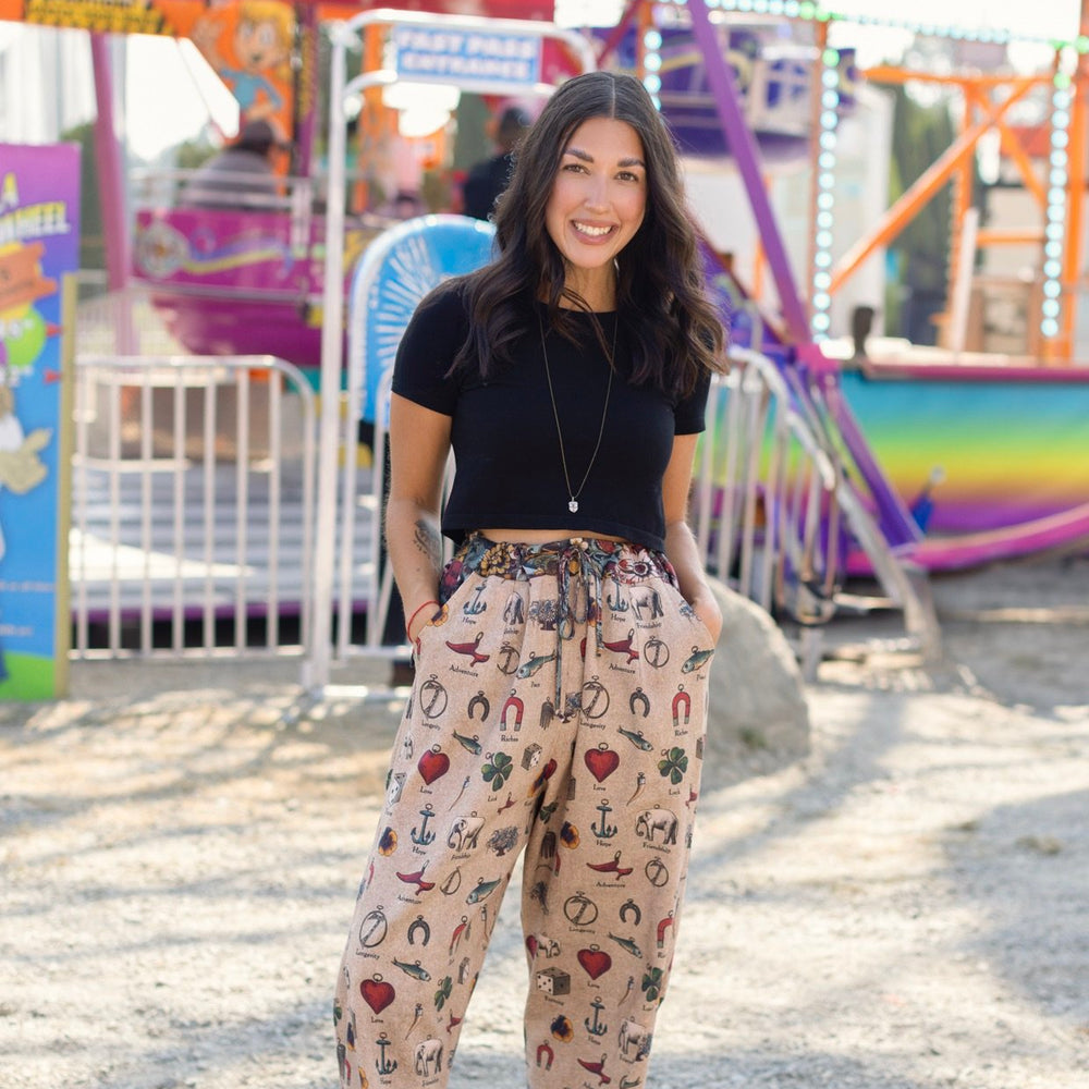 
                  
                    Charmed Life Artist Pants featuring playful Victorian luck charms and floral trim on breathable linen & bamboo/wood viscose – Market of Stars.
                  
                