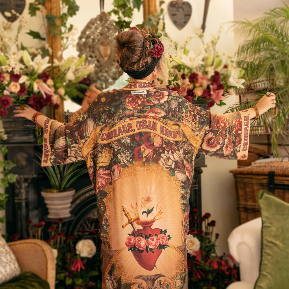 
                  
                    Model wearing Take Heart Opera Duster featuring Victorian Sacred Heart art, hidden affirmations of love, courage, and strength on bamboo-based viscose – Market of Stars
                  
                