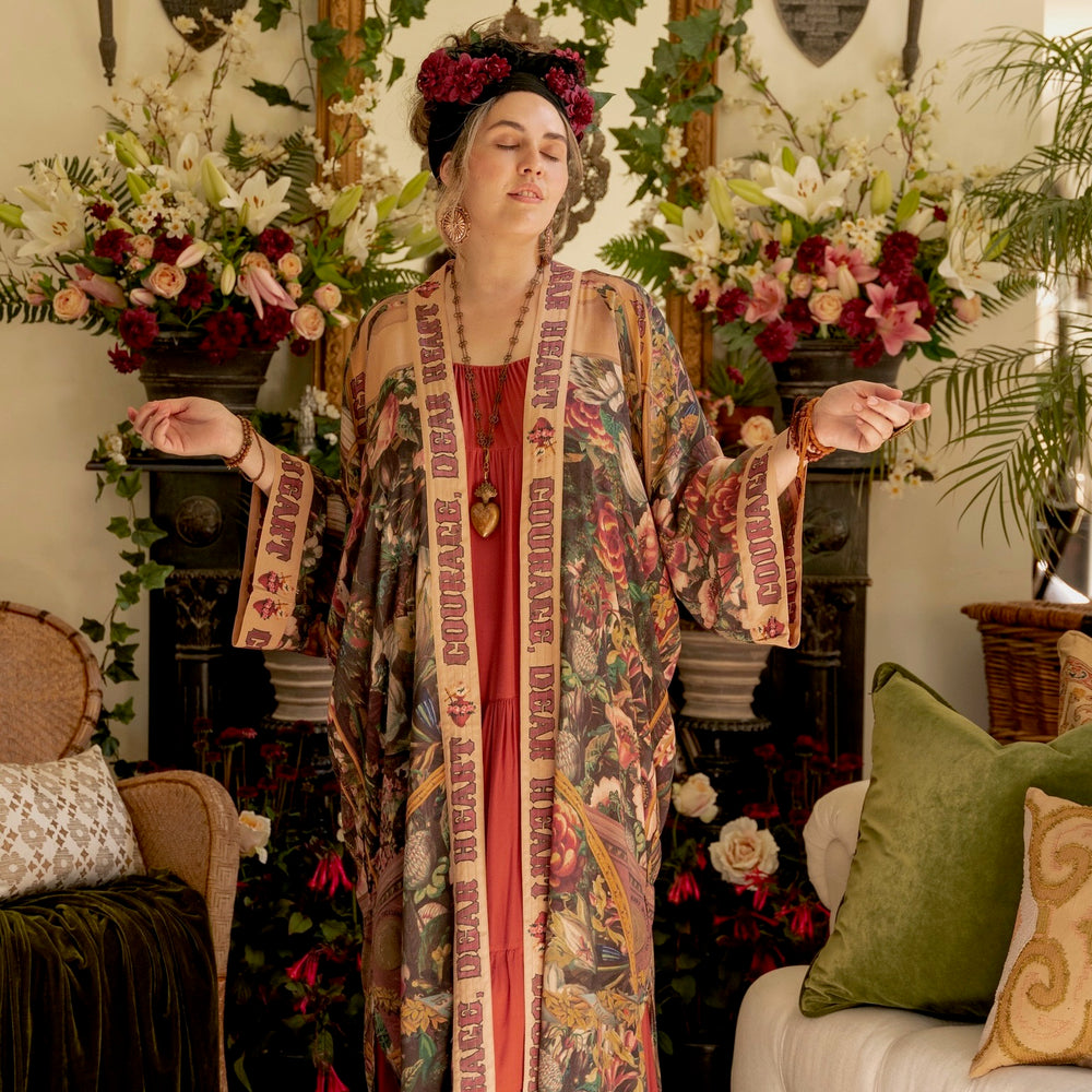 
                  
                    Model wearing Take Heart Opera Duster featuring Victorian Sacred Heart art, hidden affirmations of love, courage, and strength on bamboo-based viscose – Market of Stars
                  
                