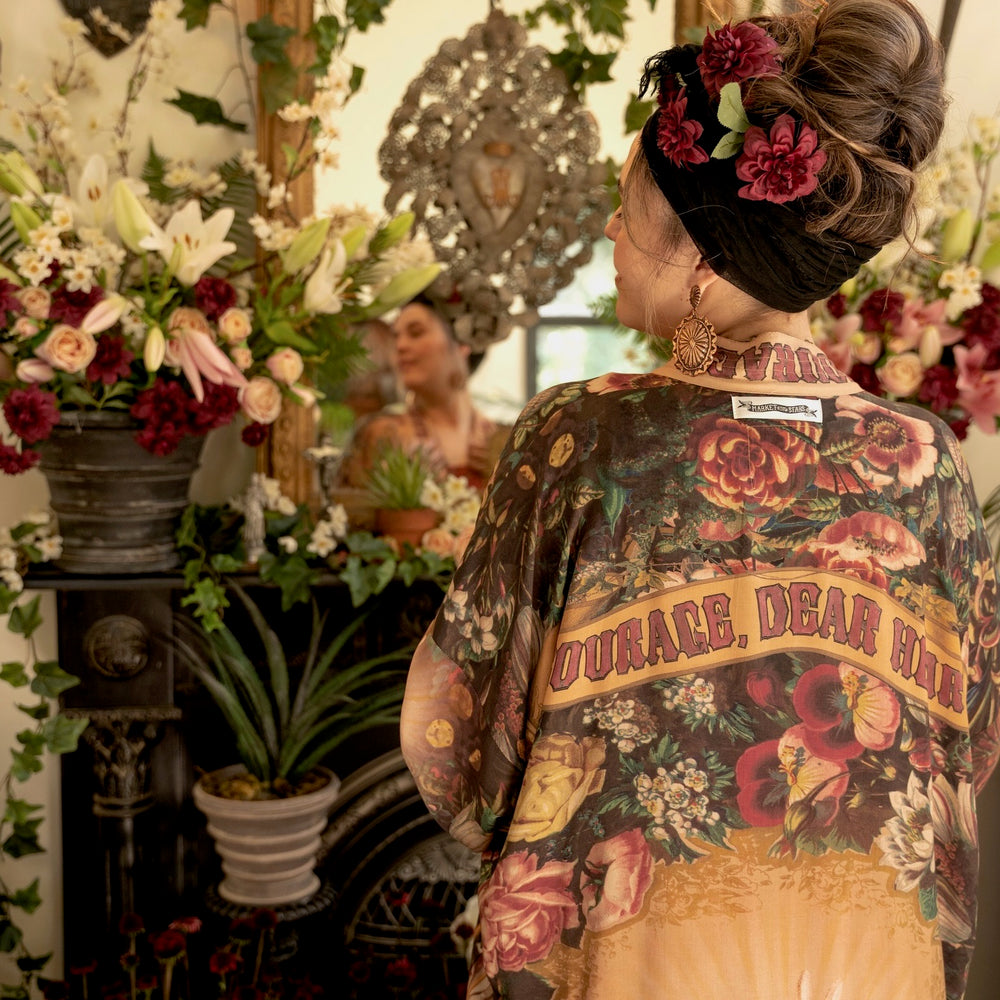 
                  
                    Model wearing Take Heart Opera Duster featuring Victorian Sacred Heart art, hidden affirmations of love, courage, and strength on bamboo-based viscose – Market of Stars
                  
                
