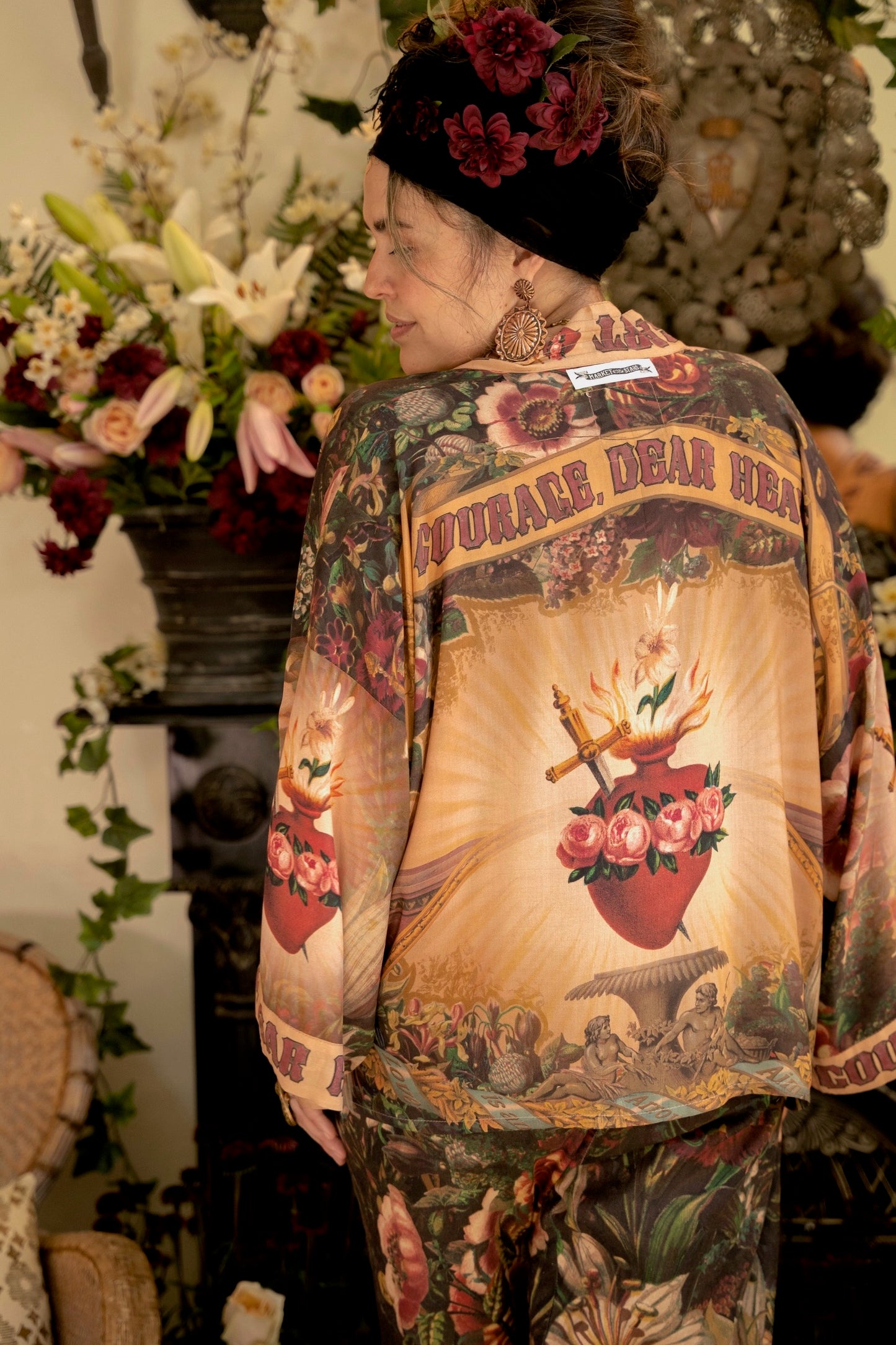 Model wearing Courage Dear Heart Pixie cut Duster featuring Victorian Sacred Heart art and hidden affirmations of courage and love on bamboo-based viscose – Market of Stars.