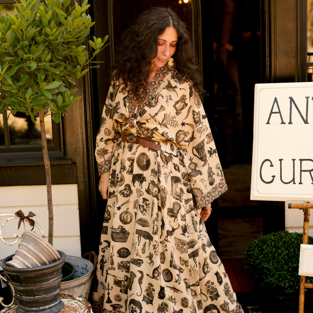 
                  
                    Model wearing a maxi-length bamboo viscose slip dress inspired by a mysterious Victorian scrapbook. This whimsical print celebrates the wonder hidden in ordinary things — Market of Stars.
                  
                