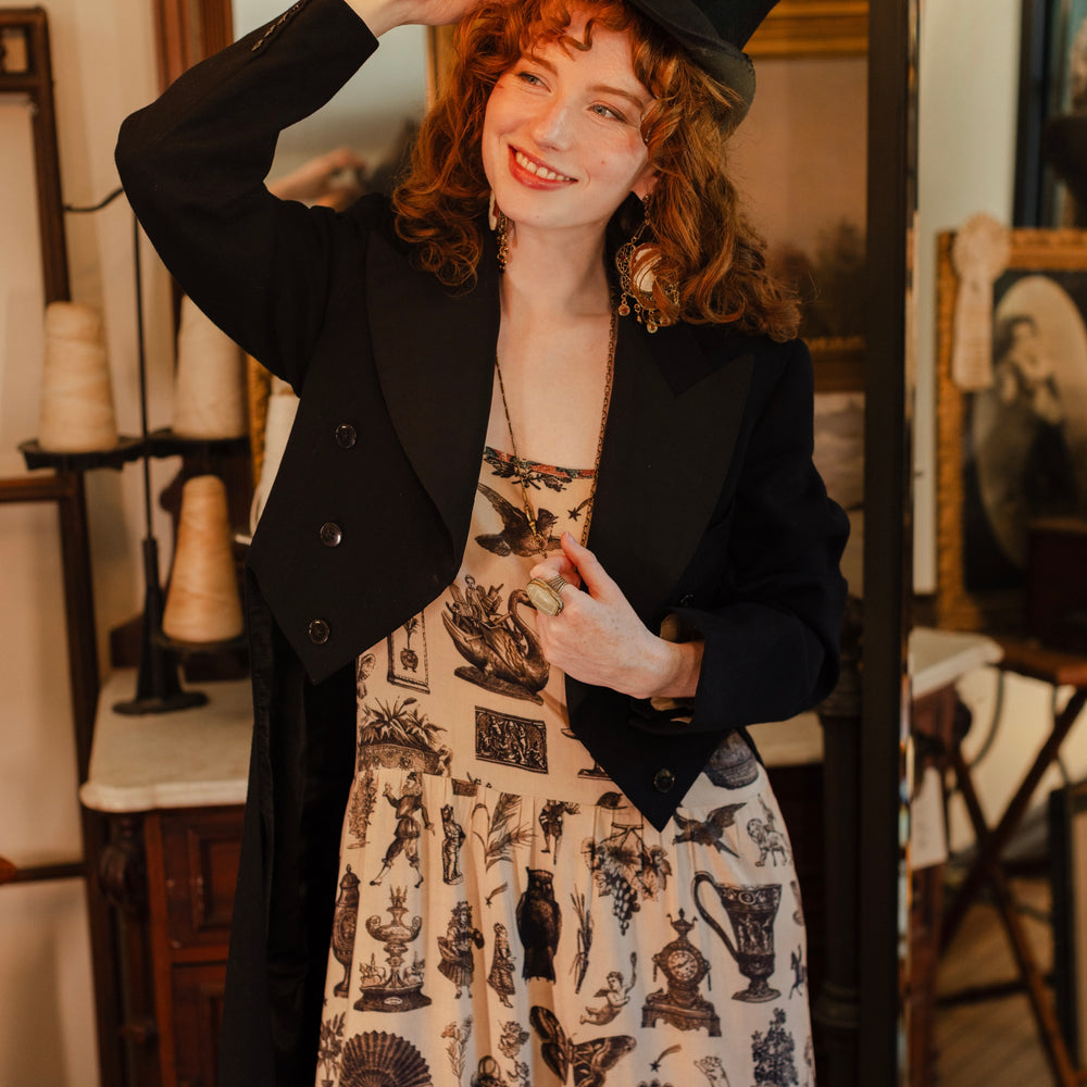 
                  
                    Model wearing a maxi-length bamboo viscose slip dress inspired by a mysterious Victorian scrapbook. This whimsical print celebrates the wonder hidden in ordinary things — Market of Stars.
                  
                