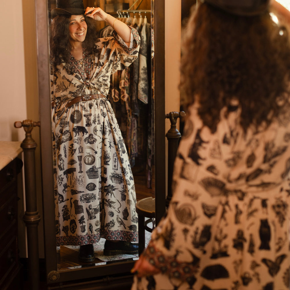 
                  
                    Model wearing a maxi-length bamboo viscose slip dress inspired by a mysterious Victorian scrapbook. This whimsical print celebrates the wonder hidden in ordinary things — Market of Stars.
                  
                