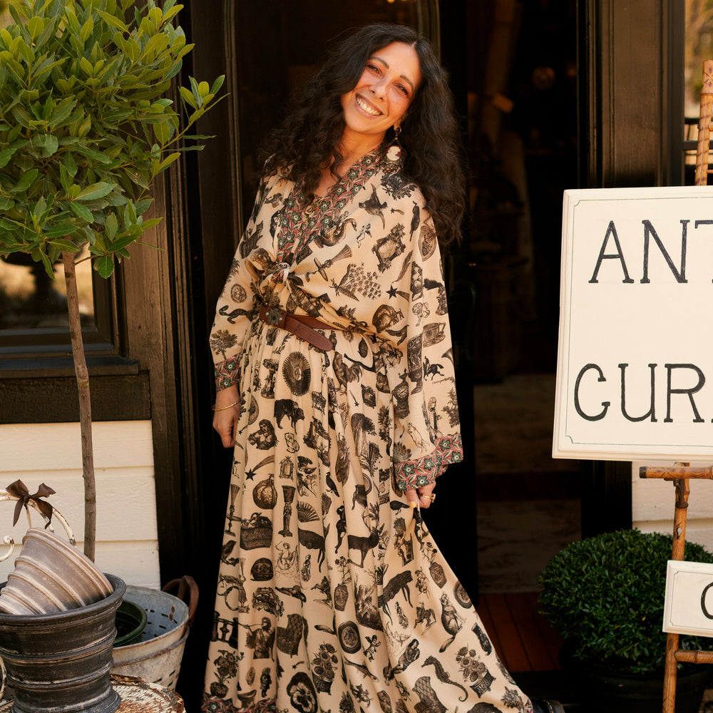 
                  
                    Model wearing a bamboo-viscose cropped length duster inspired by a mysterious Victorian scrapbook. This whimsical print celebrates the wonder hidden in ordinary things — Market of Stars.
                  
                