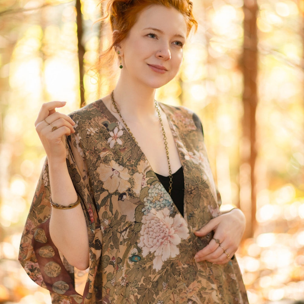 
                  
                    Dreamweaver Goddess Duster featuring Alphonse Mucha’s 1896 zodiac woman, celestial crown, and burgundy zodiac trim inspired by vintage bohemian style – Market of Stars
                  
                
