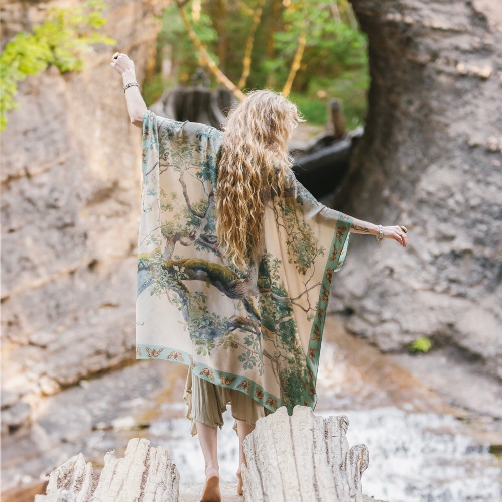 
                  
                    Model wearing the Earth and Sky Goddess length kimono featuring majestic trees by Charles Aston and antique moth illustrations – a dreamy tribute to nature – Market of Stars.
                  
                