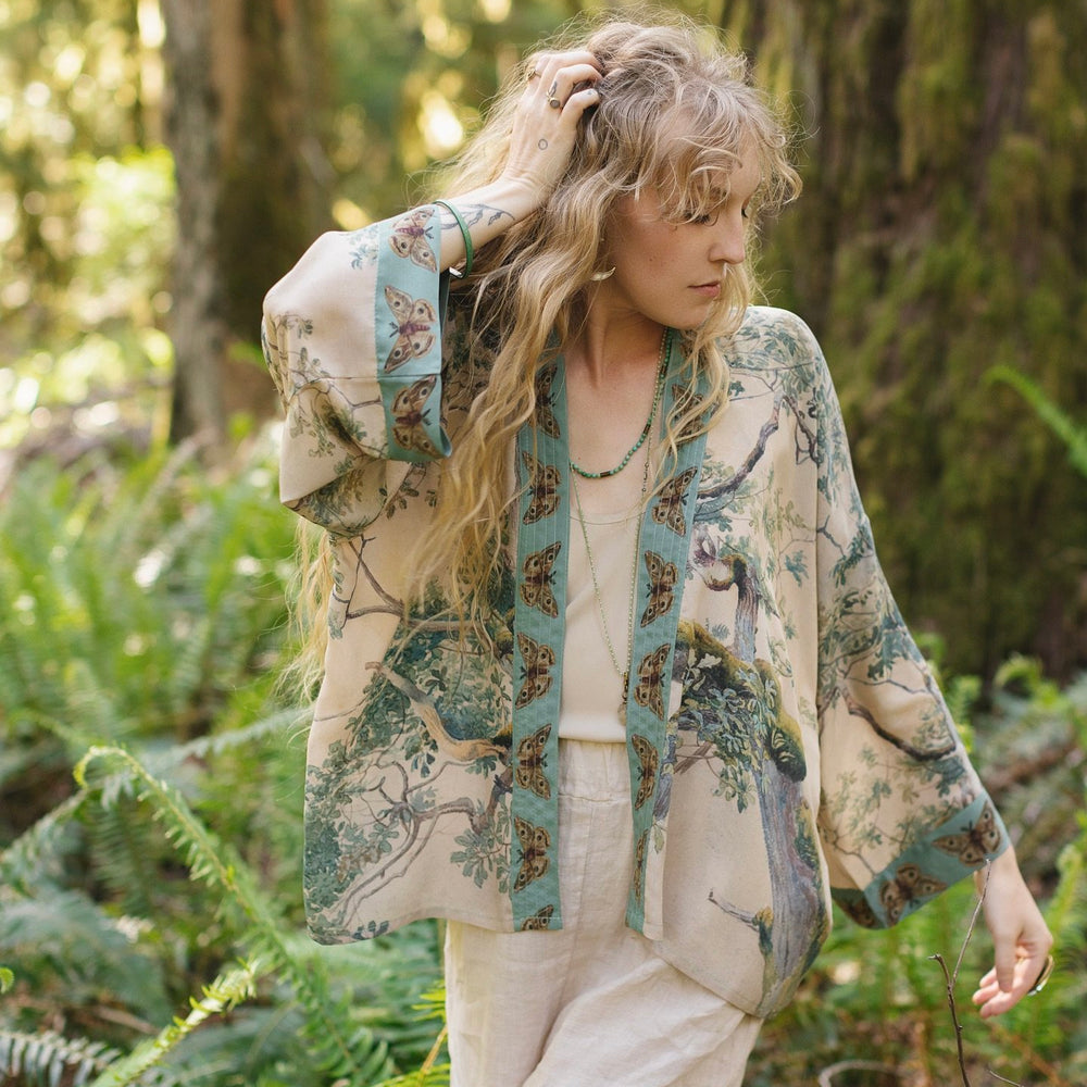 Model wearing Earth and Sky Pixie Duster featuring Charles Aston’s tree art and antique moth illustrations – a soft, nature-inspired layering piece – Market of Stars.