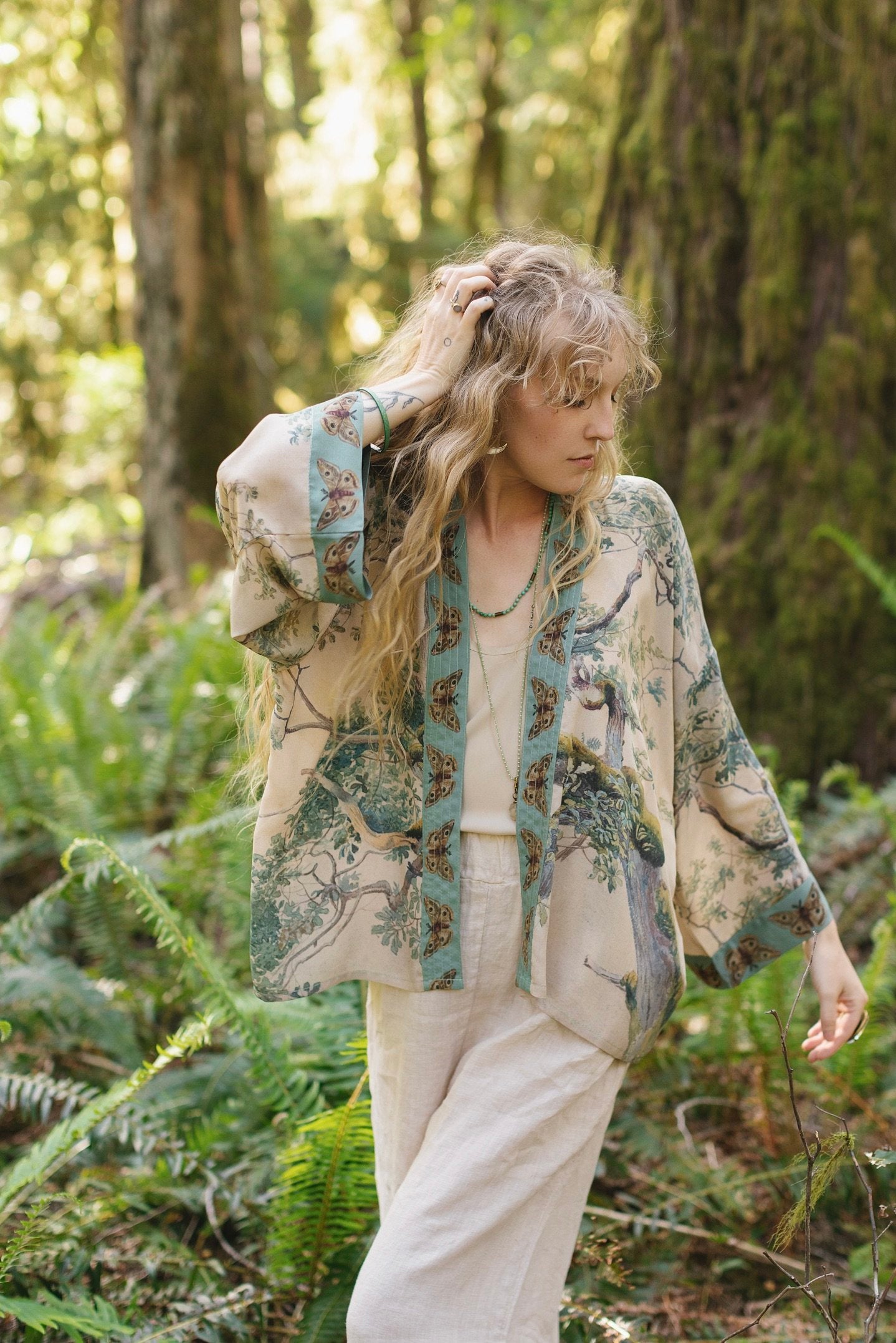 Model wearing Earth and Sky Pixie Duster featuring Charles Aston’s tree art and antique moth illustrations – a soft, nature-inspired layering piece – Market of Stars.