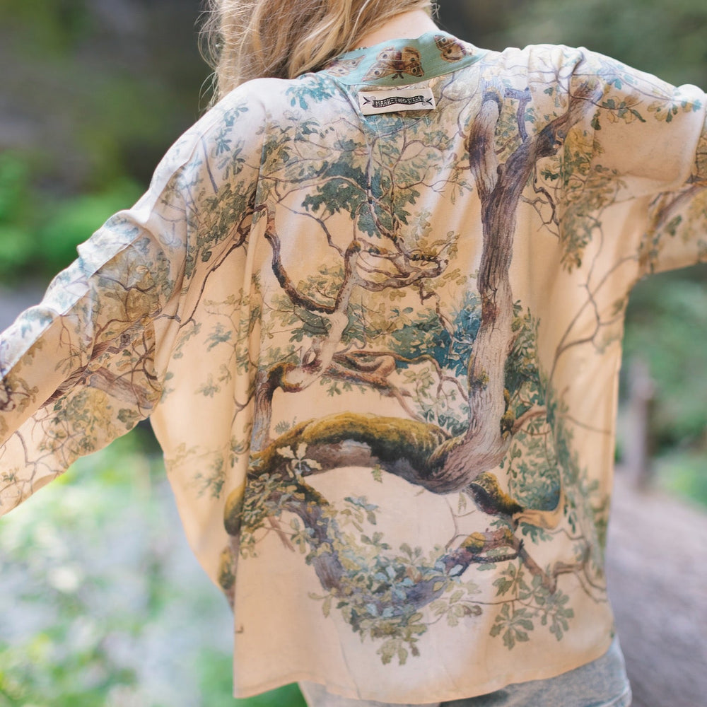 Model wearing Earth and Sky Pixie Duster featuring Charles Aston’s tree art and antique moth illustrations – a soft, nature-inspired layering piece – Market of Stars.