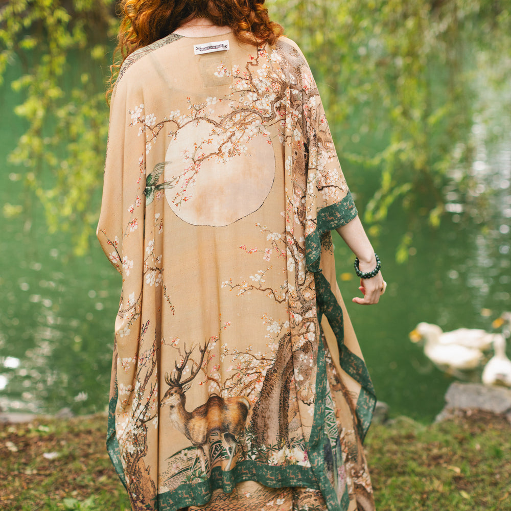 Model wearing Fable Goddess Duster featuring antique Japanese art, cherry and peach blossoms, nightingales, deer, and French block prints - Market of Stars