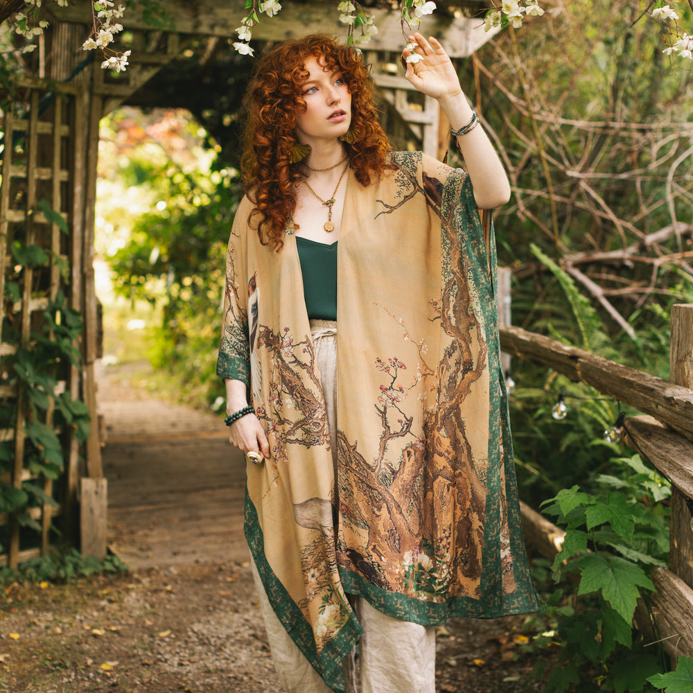 Model wearing Fable Goddess Duster featuring antique Japanese art, cherry and peach blossoms, nightingales, deer, and French block prints - Market of Stars