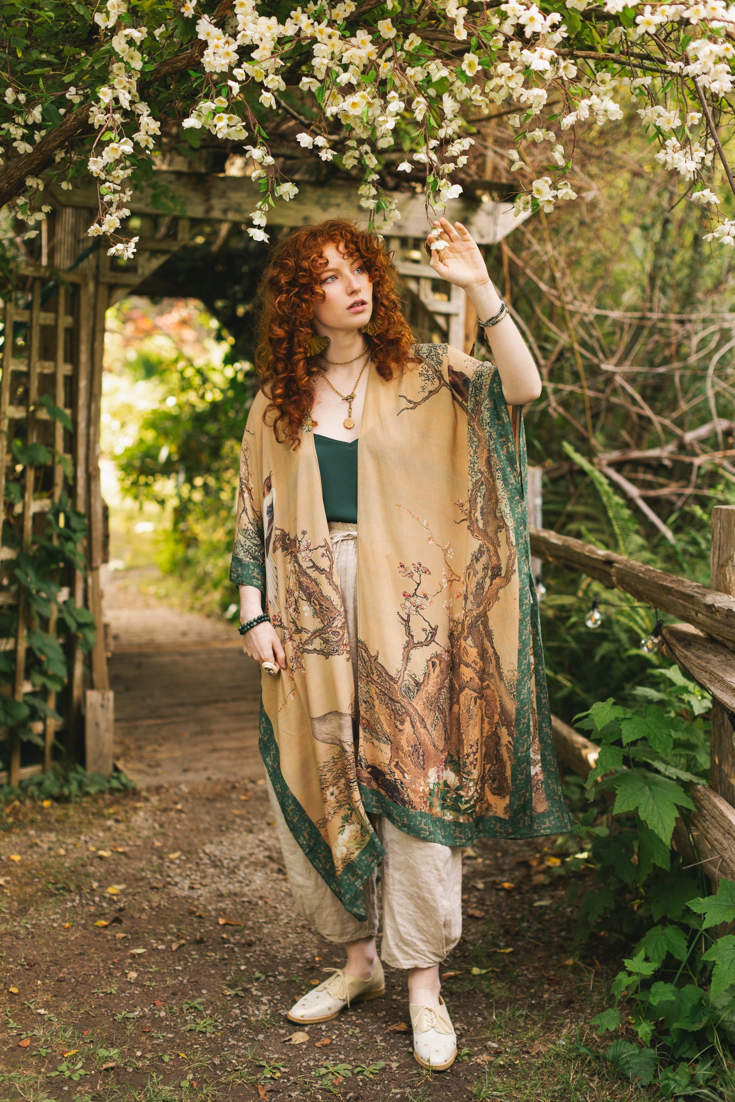 Model wearing Fable Goddess Duster featuring antique Japanese art, cherry and peach blossoms, nightingales, deer, and French block prints - Market of Stars