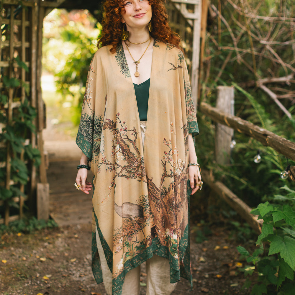 
                  
                    Model wearing Fable Goddess Duster featuring antique Japanese art, cherry and peach blossoms, nightingales, deer, and French block prints - Market of Stars
                  
                