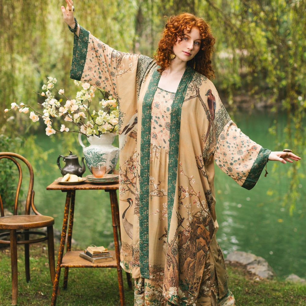 Model wearing Fable Opera Duster featuring antique Japanese art, cherry and peach blossoms, nightingales, deer, and French block prints - Market of Stars