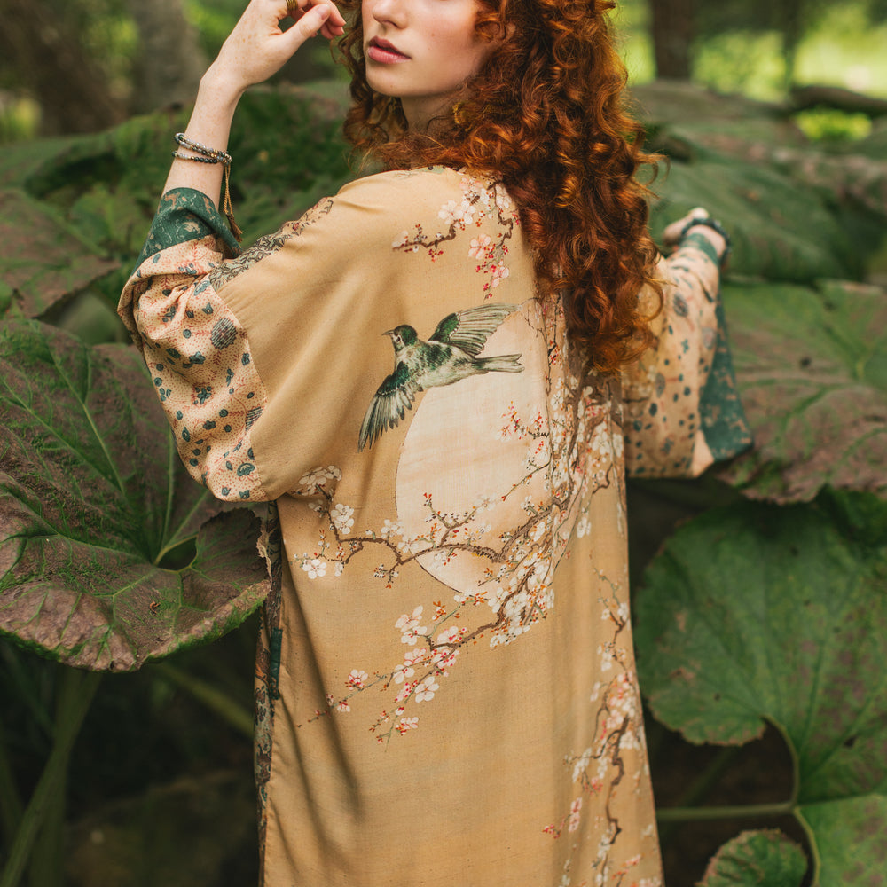 Model wearing Fable Opera Duster featuring antique Japanese art, cherry and peach blossoms, nightingales, deer, and French block prints - Market of Stars