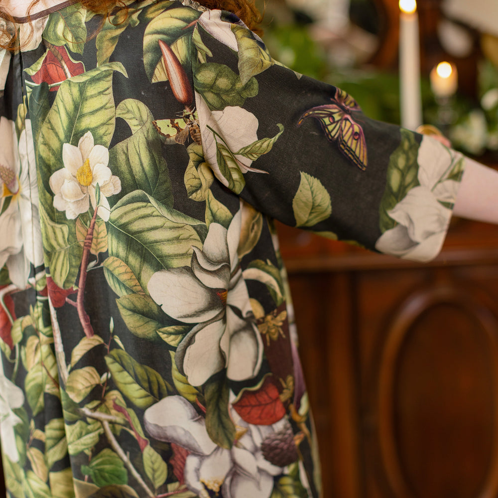
                  
                    Model wearing Fleur De Lune Artist Dress featuring vintage magnolia lithographs, delicate moth etchings and bumblebee detail - inspired by the French chemise - Market of Stars
                  
                