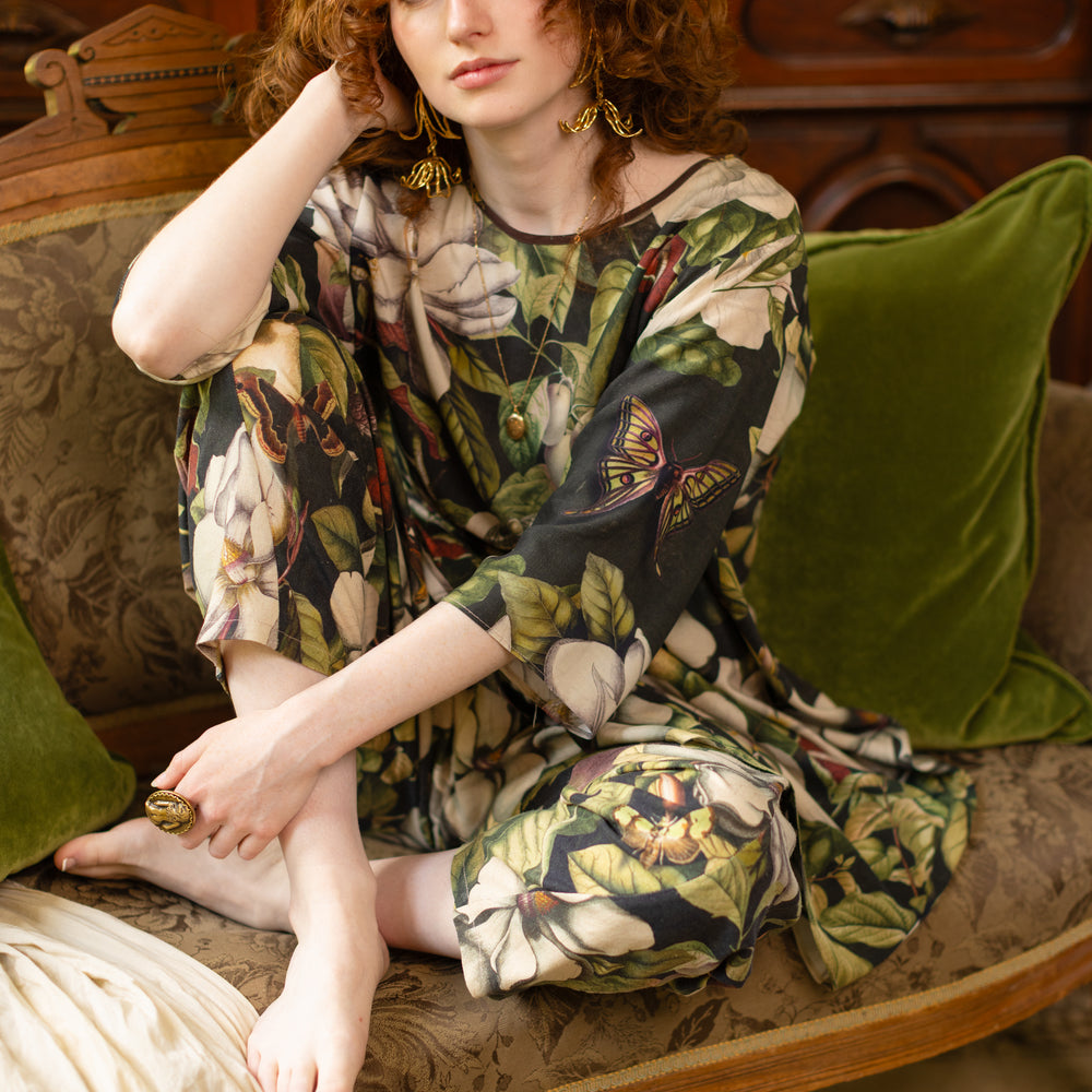 
                  
                    Model wearing Fleur De Lune Artist Dress featuring vintage magnolia lithographs, delicate moth etchings and bumblebee detail - inspired by the French chemise - Market of Stars
                  
                