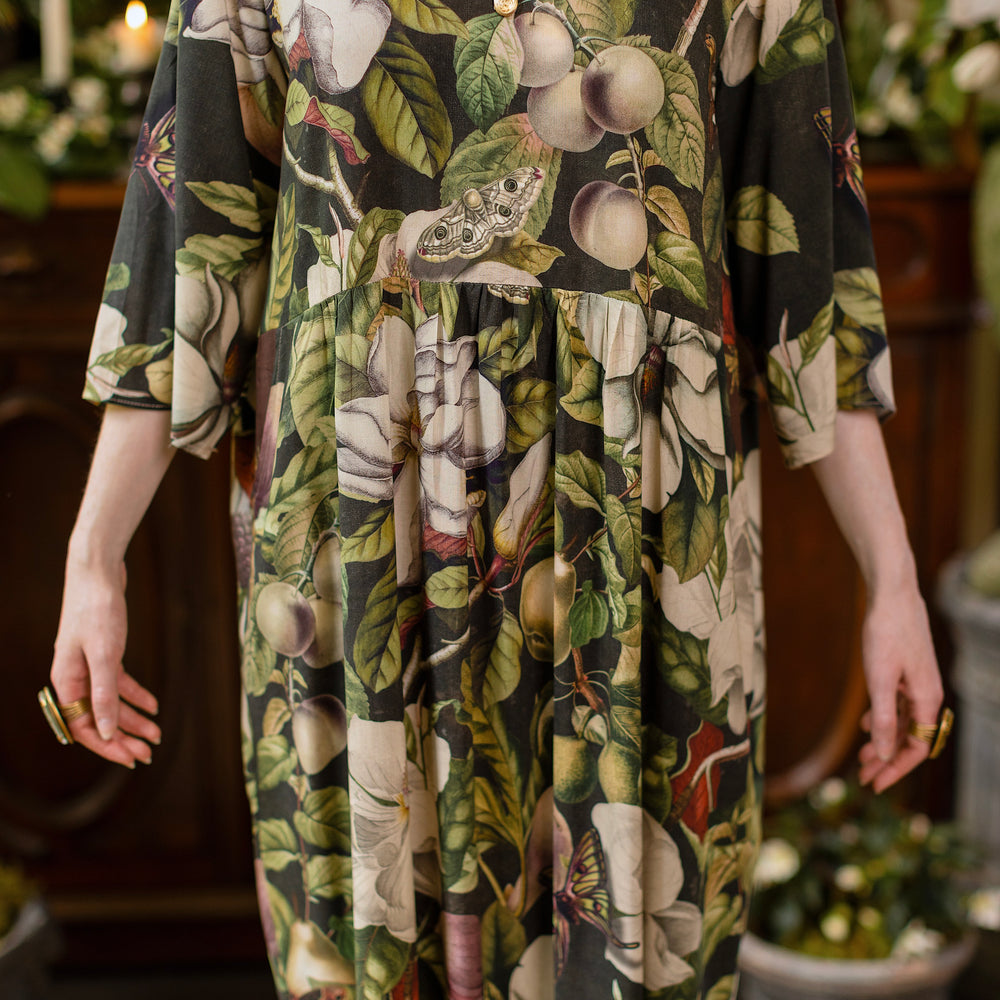 
                  
                    Model wearing Fleur De Lune Artist Dress featuring vintage magnolia lithographs, delicate moth etchings and bumblebee detail - inspired by the French chemise - Market of Stars
                  
                