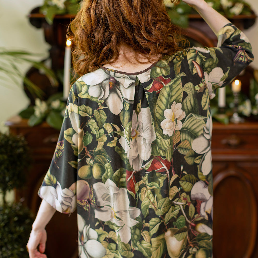 
                  
                    Model wearing Fleur De Lune Artist Dress featuring vintage magnolia lithographs, delicate moth etchings and bumblebee detail - inspired by the French chemise - Market of Stars
                  
                