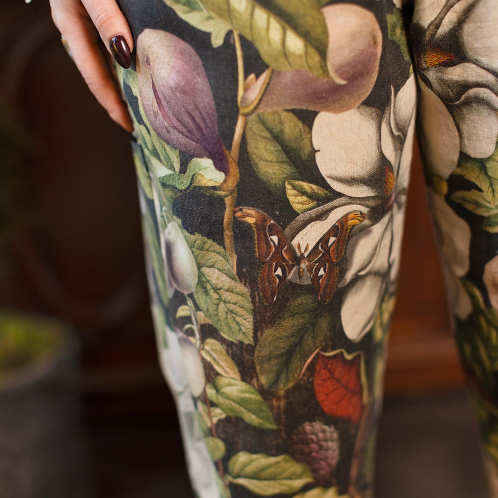 
                  
                    Model wearing Fleur De Lune Artist Pants with lantern-hem silhouette featuring antique magnolia lithographs, delicate moth etchings, and charming bumblebee trim - Market of Stars
                  
                