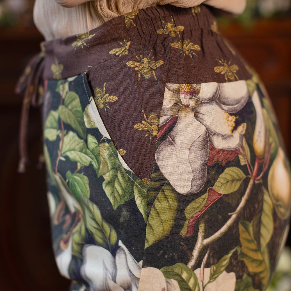
                  
                    Model wearing Fleur De Lune Artist Pants with lantern-hem silhouette featuring antique magnolia lithographs, delicate moth etchings, and charming bumblebee trim - Market of Stars
                  
                