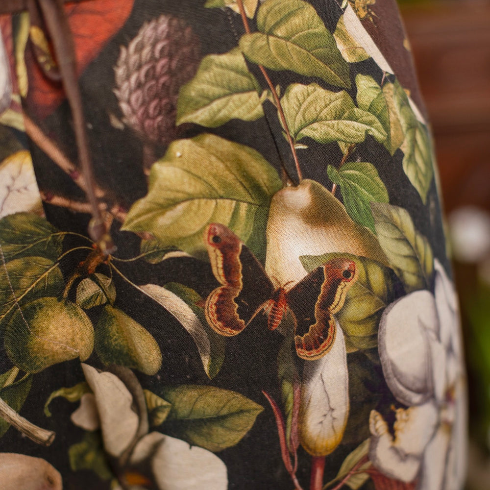 
                  
                    Model wearing Fleur De Lune Artist Pants with lantern-hem silhouette featuring antique magnolia lithographs, delicate moth etchings, and charming bumblebee trim - Market of Stars
                  
                