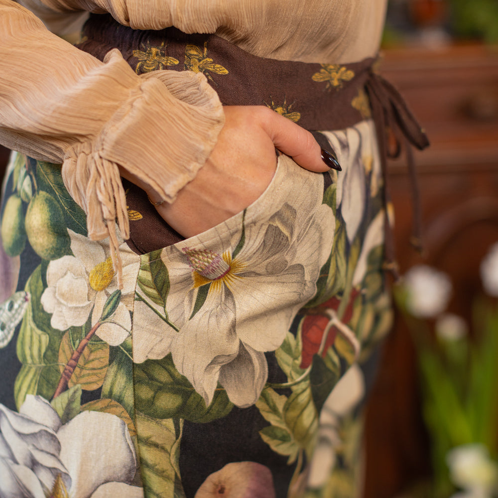 
                  
                    Model wearing Fleur De Lune Artist Pants with lantern-hem silhouette featuring antique magnolia lithographs, delicate moth etchings, and charming bumblebee trim - Market of Stars
                  
                