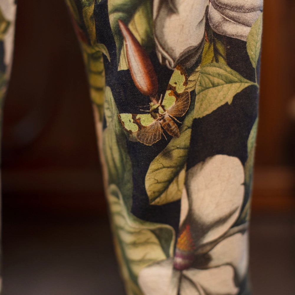 
                  
                    Model wearing Fleur De Lune Artist Pants with lantern-hem silhouette featuring antique magnolia lithographs, delicate moth etchings, and charming bumblebee trim - Market of Stars
                  
                