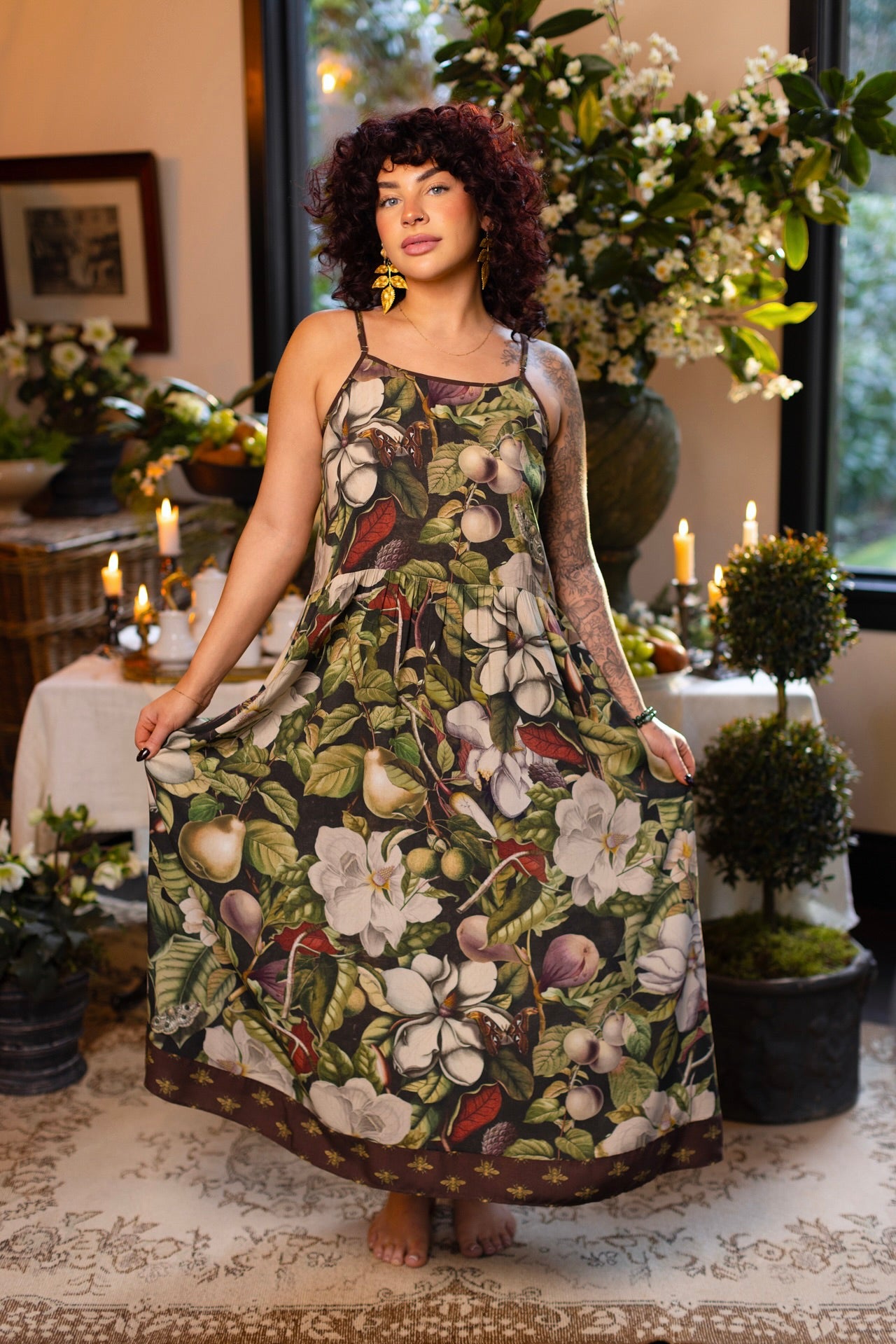 Model wearing a maxi-length slip dress featuring vintage magnolia lithographs, delicate moth etchings, and charming bumblebee trim - Market of Stars