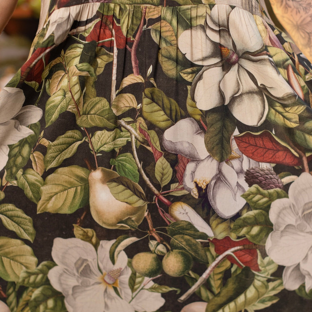 
                  
                    Model wearing a maxi-length slip dress featuring vintage magnolia lithographs, delicate moth etchings, and charming bumblebee trim - Market of Stars
                  
                