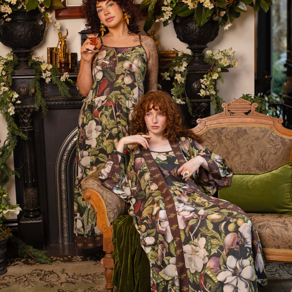 
                  
                    Model wearing a maxi-length slip dress featuring vintage magnolia lithographs, delicate moth etchings, and charming bumblebee trim - Market of Stars
                  
                