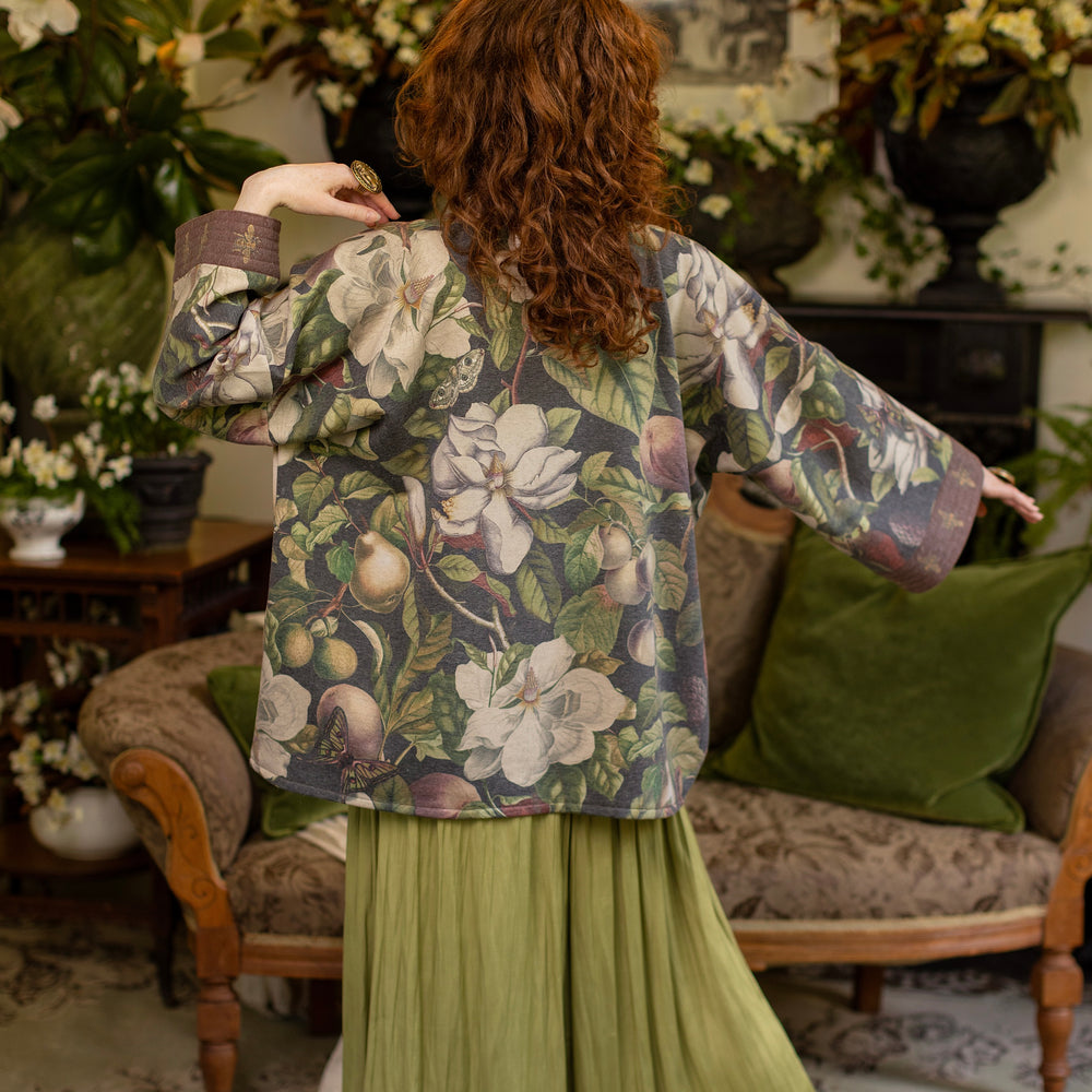 Model wearing a cozy cardigan lined with fleece featuring vintage magnolia lithographs, delicate moth etchings, and charming bumblebee trim - Market of stars