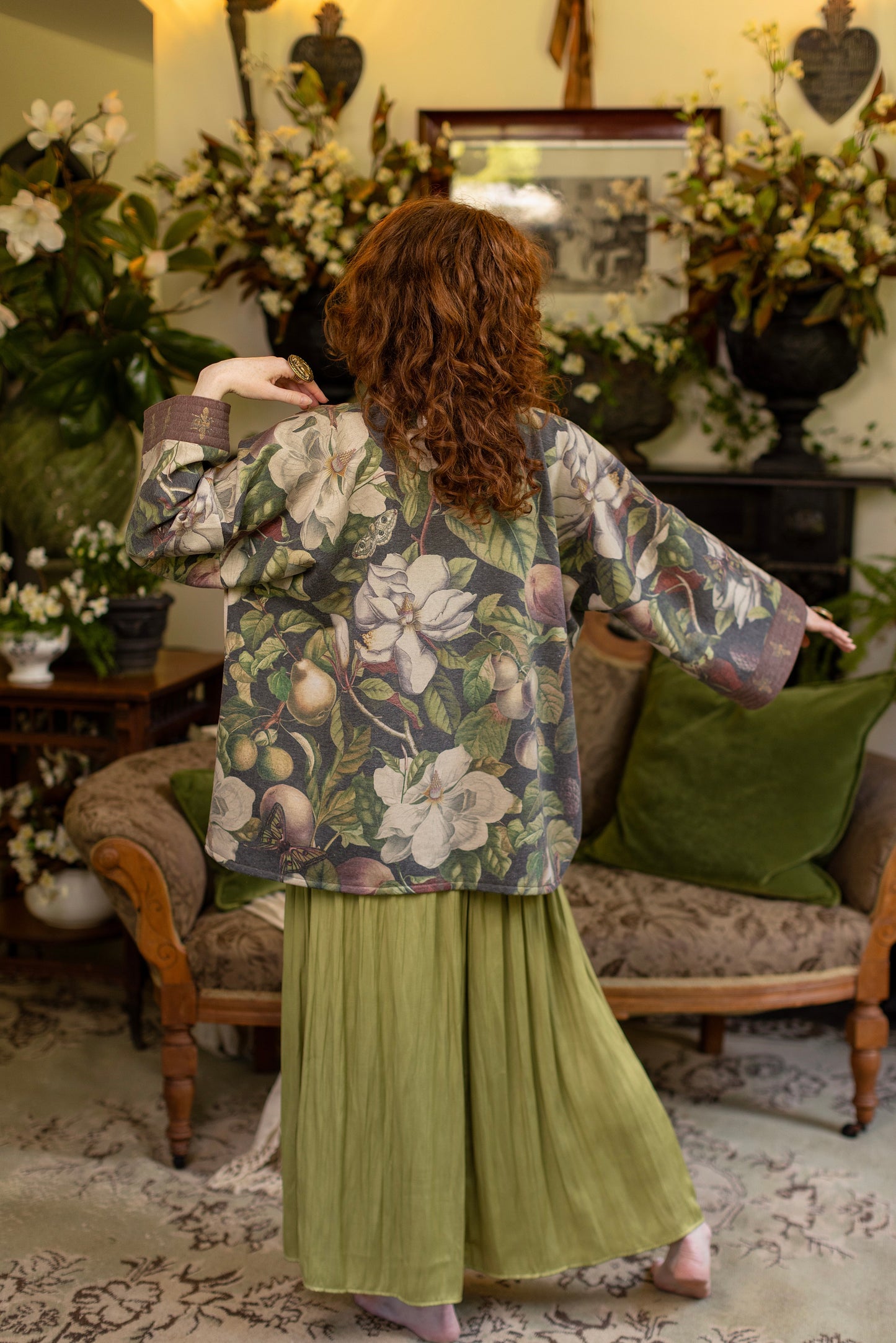 Model wearing a cozy cardigan lined with fleece featuring vintage magnolia lithographs, delicate moth etchings, and charming bumblebee trim - Market of stars